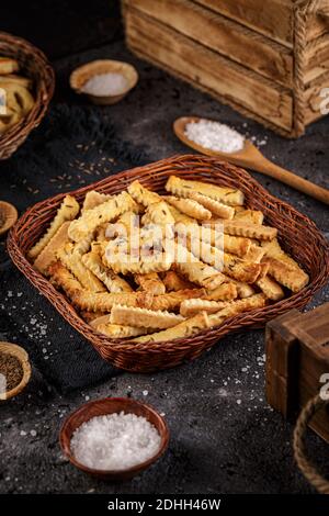 Homemade salt sticks with cummin  in little wicker basket Stock Photo