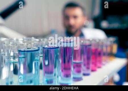 Young Scientist lookin at the camera. Man Wears Protective Goggles Stock Photo