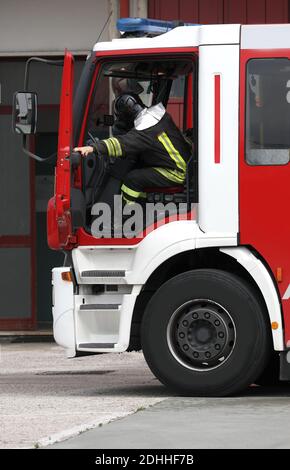 Rome, RM, Italy - May 30, 2019: italian fireman quickly gets out of the fire truck during an emergency Stock Photo