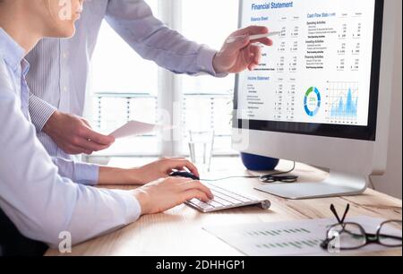 Accountants working on financial statement on computer screen in office. Team of consulant auditing finance and business operations reports with incom Stock Photo