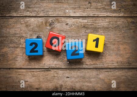 Year 2021 set with toy number blocks on rustic wooden background Stock Photo