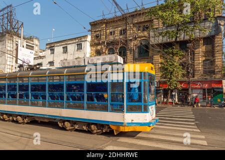 Kolkata tram on city road with old heritage buildings at Esplanade   Dharmatala area, India Stock Photo