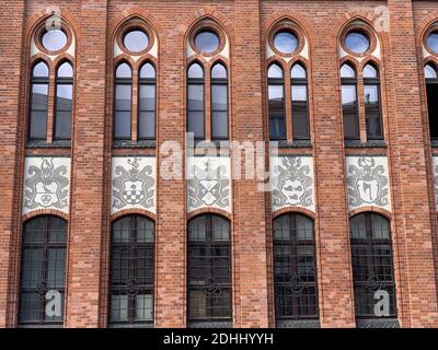 A facade of an old building made of red bricks Stock Photo