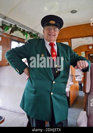 Ticket inspector on the Chinnor and Princes Risborough Railway in winter. Oxfordshire, UK Stock Photo