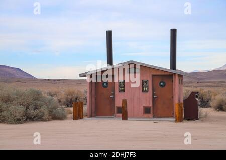 INDEPENDENCE, CALIFORNIA, UNITED STATES - Dec 06, 2020: Vault toilets stand at the edge of a Taboose Creek Campground. Stock Photo