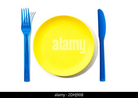 Colorful plastic Empty Plate, fork and knife isolated on white background. Mock up Top view Stock Photo