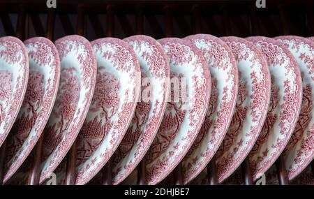 Ceramic plates with patterns on the shelf close-up in row