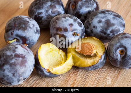 Many plums on wooden table Stock Photo