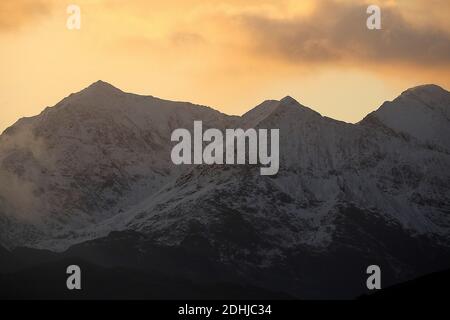 Sunset over the Snowdon horseshoe across showing recent snowfall. Wales. Picture taken 5th December 2020