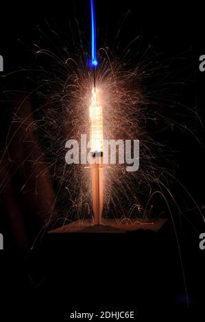 Medical science - hypodermic syringe disperses lighting and fireworks Stock Photo
