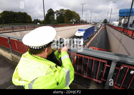 Police traffic officer holding speed checks over the A34 underpass as transport bosses have launched a clampdown on speeding motorists through 20mph road works on Aldridge Road and A34 junctions to make way for major regeneration. Officers from West Midlands Police will be holding regular speed checks as working contractors carryout construction around the Perry Barr area, Birmingham, The Midlands, England. Stock Photo