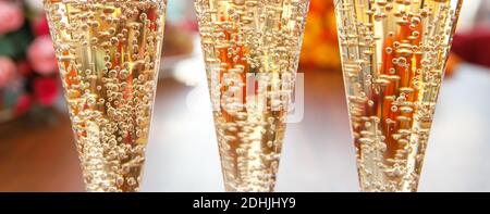 Glasses of sparkling wine in the light close-up. Lots of gas bubbles Stock Photo