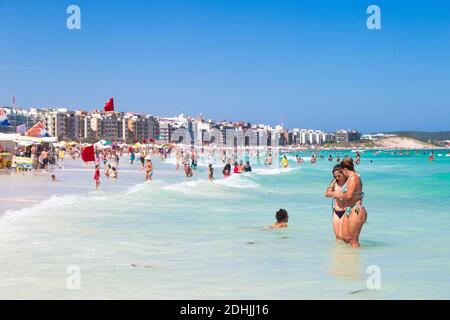 CABO FRIO, RIO DE JANEIRO, BRAZIL - DECEMBER 26, 2019: Do Forte Beach in the downtown. Panoramic View. People in the turquoise water of sea. Stock Photo