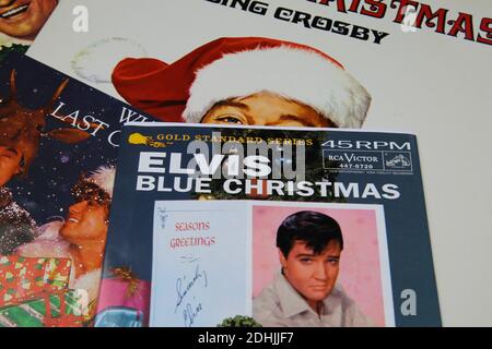 Viersen, Germany - December 9. 2020: Close up of vintage vinyl record cover singles with famous christmas songs (focus on Elvis Presley blue christmas Stock Photo