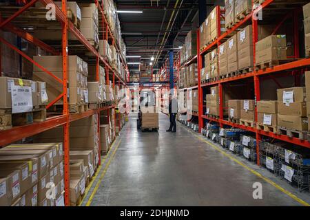 Warehouse worker with a forklift in warehouse Stock Photo