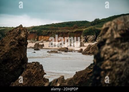 Scenery of seashore with rough rocks located in highland area on overcast day Stock Photo