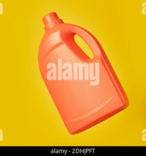 Bright plastic container from liquid detergent placed on vivid yellow background in studio Stock Photo