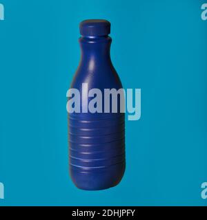 Blue plastic container from liquid detergent placed on vivid blue background in studio Stock Photo