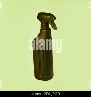 Black spray plastic container from liquid detergent placed on vivid pastel green background in studio Stock Photo