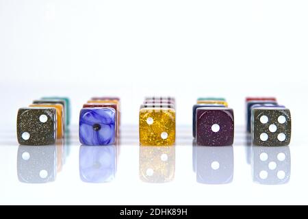 Deutschland. 08th Dec, 2020. The die is cast". Colorful dice in a row with a slight reflection on the ground in front of a neutral background. | usage worldwide Credit: dpa/Ģ����ý Live News Stock Photo