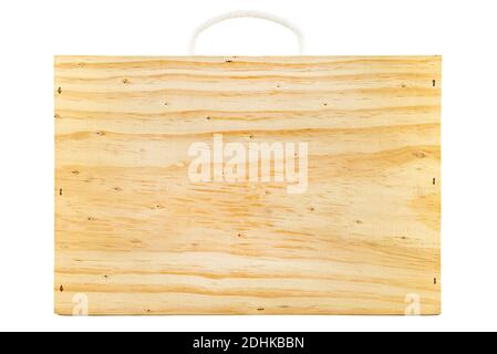Rectangular shaped wooden suitcase with rope handle, isolated on white background. Stock Photo