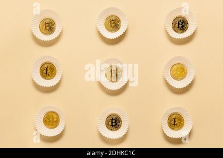 Business concept items on the table golden bitcoins, on a beige background. Bitcoins are a digital currency, the global market for trade and exchange Stock Photo