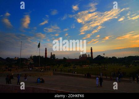 Lahore, Pakistan. 11th Dec, 2020. Pakistani people visit the greater Iqbal Park after weather turnout pleasant during an attractive stunning beautiful mesmerizing view of the colorful clouds hovering on sky at greater Iqbal Park historical Minar-e-Pakistan Lahore. (Photo by Rana Sajid Hussain/Pacific Press) Credit: Pacific Press Media Production Corp./Alamy Live News Stock Photo