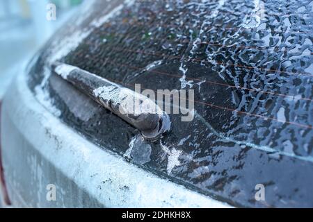 Car window and windscreen wiper in ice after freezing rain. Freezing rain, anomalies of nature. Soft focus technique Stock Photo