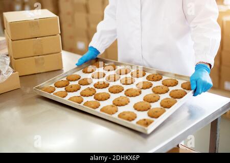 Woman holding cookie tin hi-res stock photography and images - Alamy