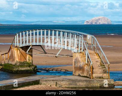 Bridge to Nowhere, Belhaven Bay on sunny day at low tide with Bass Rock in Firth of Firth on the horizon, East Lothian, Scotland, UK Stock Photo