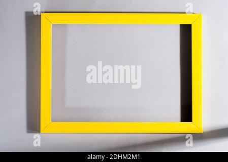 Yellow frame with shadows on grey background. Trendy colors 2021. Stock Photo