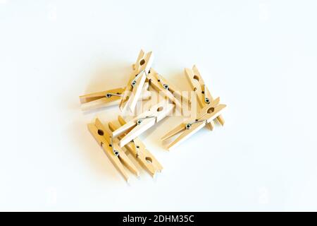 An isolated view of several wooden clothes pins on a white background Stock Photo