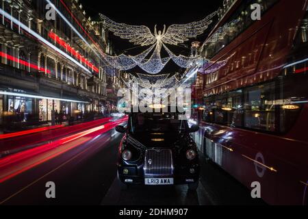 Golden angel christmas decorations and light trails on Regent Street. Stock Photo