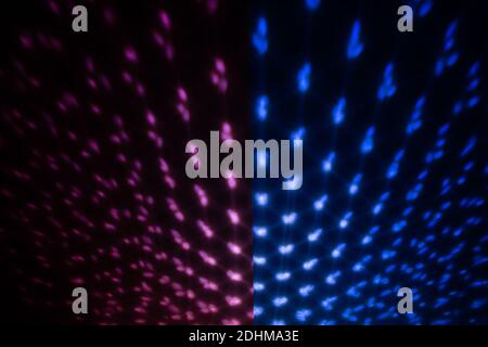 Red and blue Lighting effect on dark wall, defocused decorative abstract background. Stock Photo