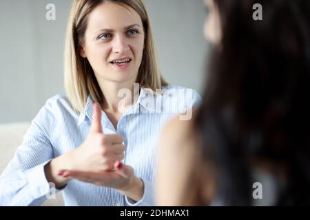Two women communicate by sign language closeup Stock Photo