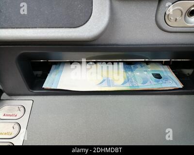 ATM cash machine while handing out euro banknotes Stock Photo