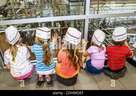 Alabama Sylacauga Blue Bell Creameries ice cream manufacturing plant production,children boys girls tour school field trip students wearing hats,looki Stock Photo