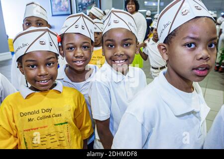 Alabama Sylacauga Blue Bell Creameries ice cream manufacturing plant production,inside interior Black children tour boys girls wearing hats, Stock Photo