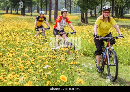 Birmingham Alabama,Oak Mountain State Park,mountain bike trail man woman female women riding bicycles wildflowers flowers, Stock Photo