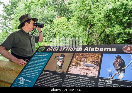 Alabama Decatur Hospitality Nature Park birding birder,man binoculars looking sign information, Stock Photo