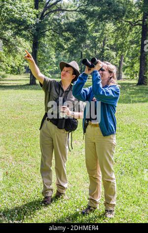 Alabama Decatur Hospitality Nature Park birding birder,man binoculars woman female couple looking points pointing, Stock Photo