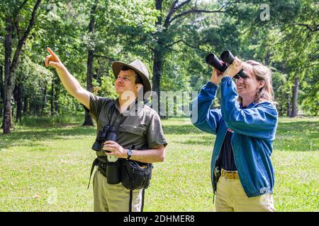 Alabama Decatur Hospitality Nature Park birding birder,man binoculars woman female couple looking points pointing, Stock Photo