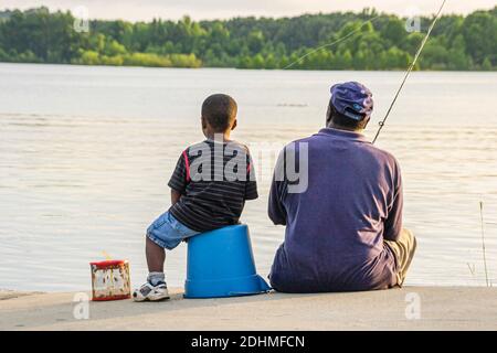 Alabama Lake Eufaula Lakepoint Resort State Park,Chattahoochee River wetland upland habitat,Black father son man boy fishing, Stock Photo