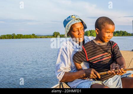 Alabama Lake Eufaula Lakepoint Resort State Park,Chattahoochee River wetland upland habitat,Black boy grandmother grandson fishing, Stock Photo