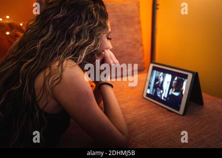 Young caucasic woman watching a series on the sofa Stock Photo