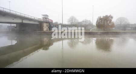 Mist rises from the Cumberland Basin as traffic passes on the Plimsoll Bridge flyover system on Bristol's Floating Harbour. Stock Photo