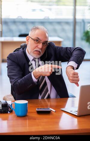 Senior businessman employee working in the office Stock Photo