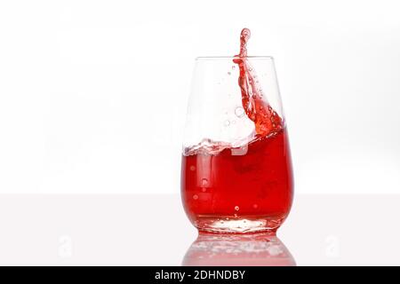 Red juice splashes on isolated white background Stock Photo