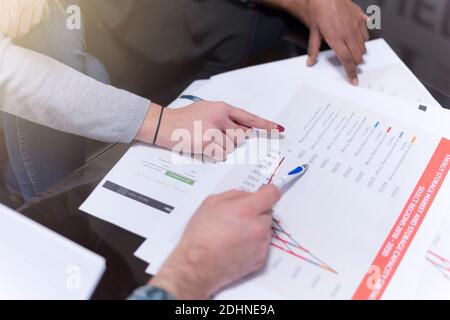 Young multiracial and multiethnic team of Business experts working together on important  financial report. Economy and business concept Stock Photo
