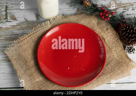 empty red plate with cookie scrap crumbs on christmas table Stock Photo